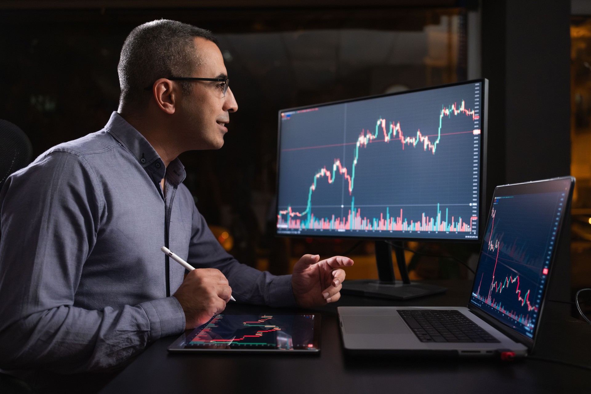 Man Checking His Stock Market Exchange Investment Using His Laptop Computer At Night.